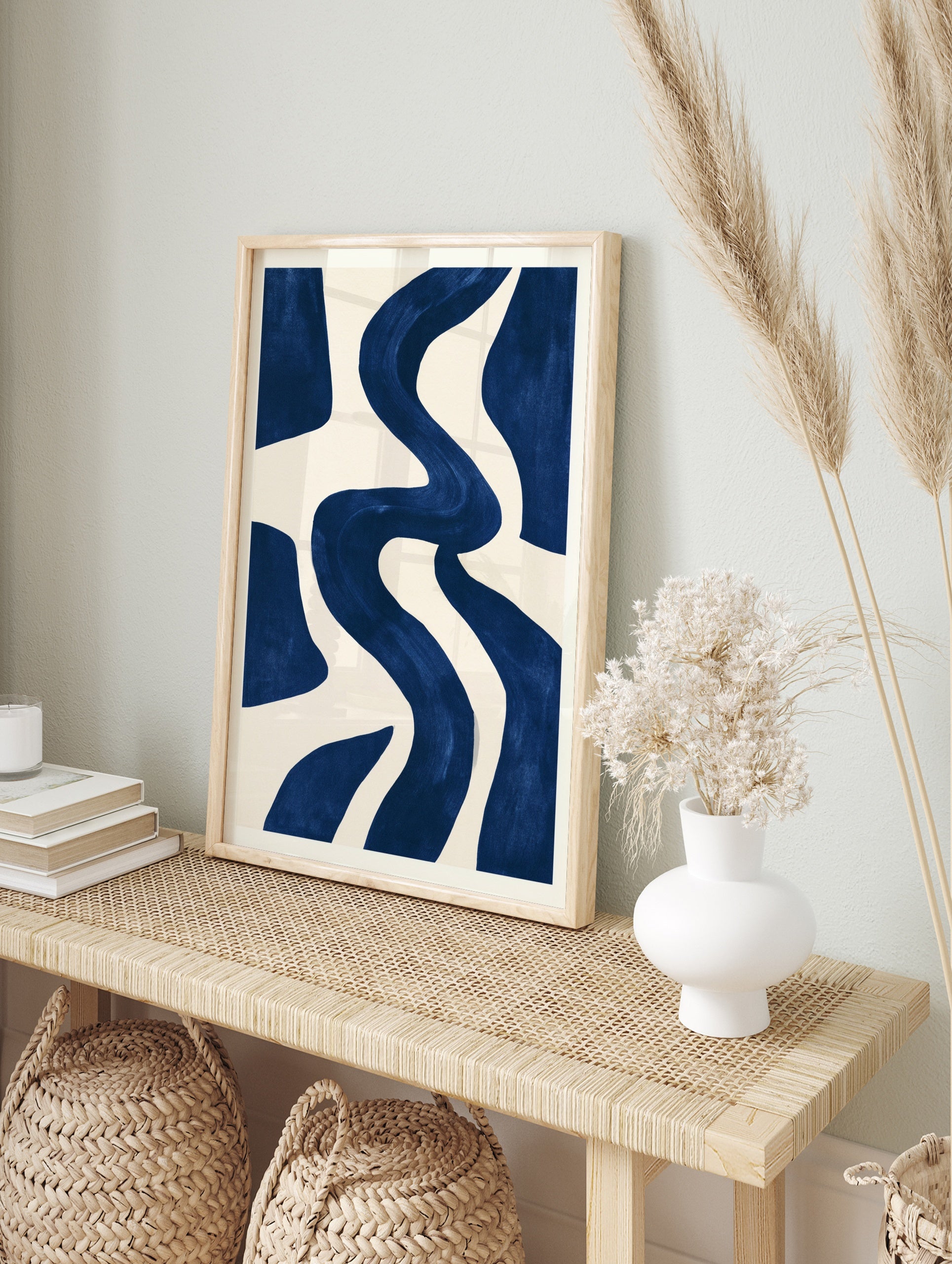 Abstract navy blue wavy shapes on a cream background, minimalist wall art print, in an alternate framed mockup