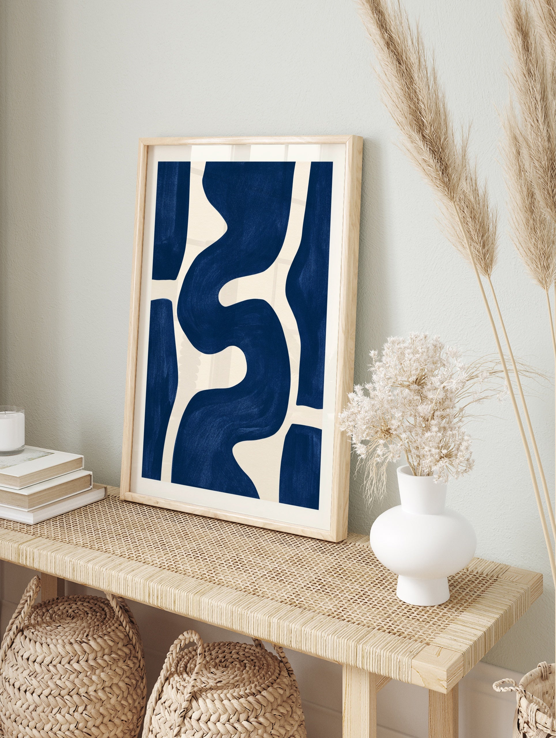 Abstract blue wave shapes on a cream background, minimalist wall art print, in an alternate framed mockup