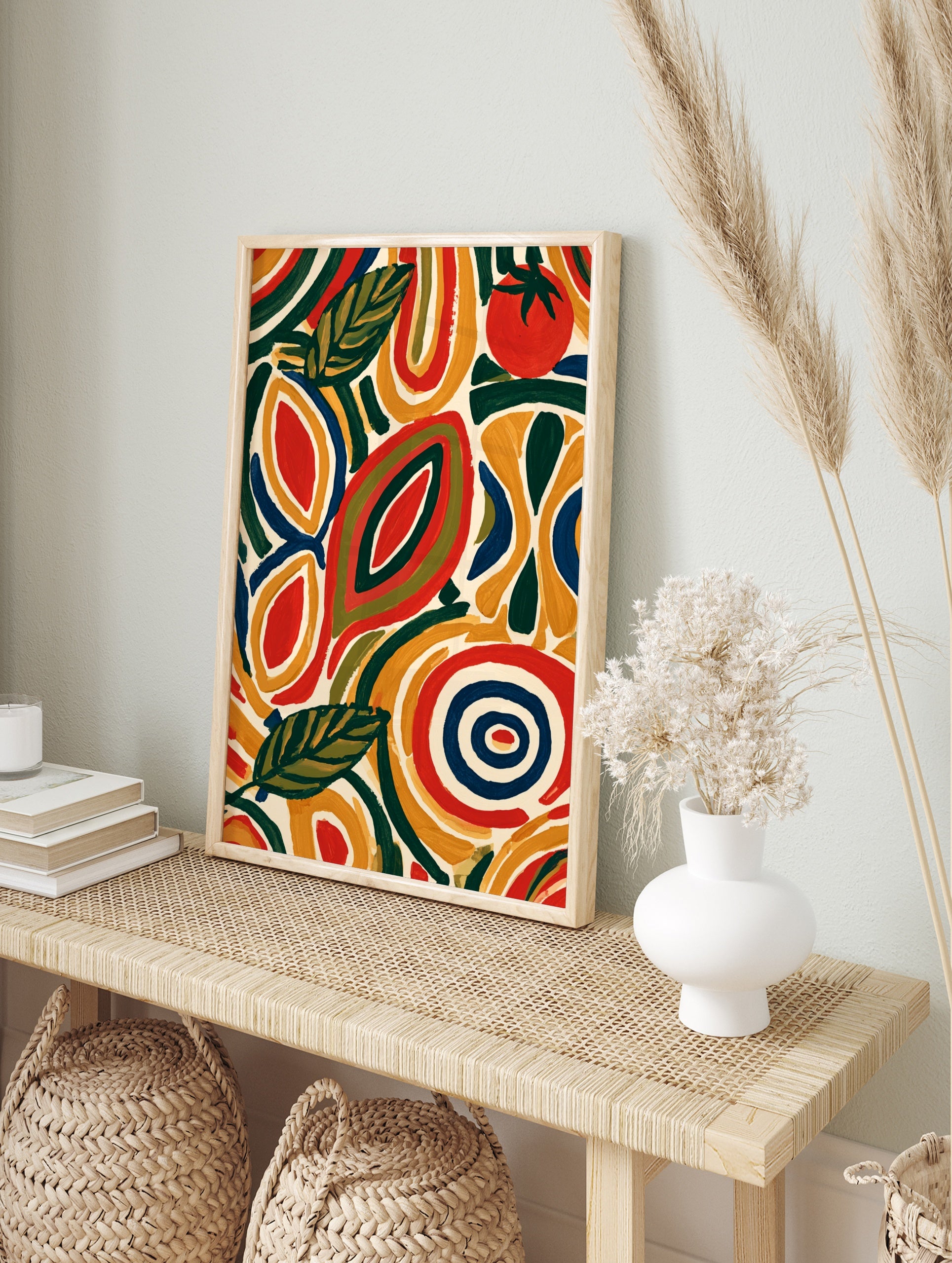 Abstract botanical wall art with stylized leaves and a red tomato in yellow, green, and navy, in an alternate framed mockup