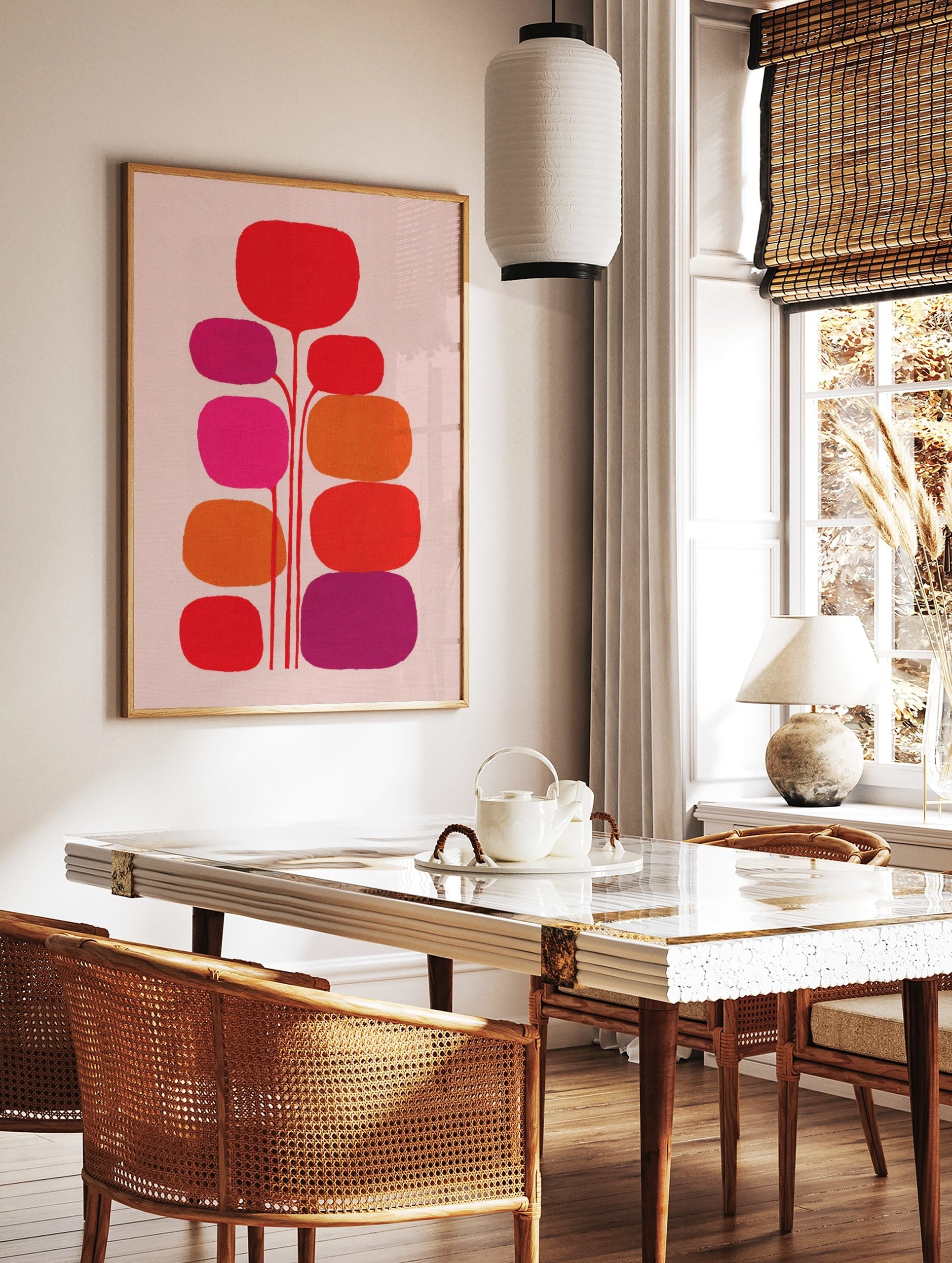 Abstract botanical wall art with red, orange, fuchsia, and purple rounded organic shapes on light, in a styled room mockup