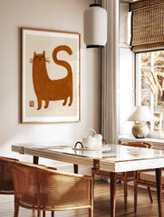 Minimalist brown cat illustration with brush-stroke texture and red seal on an off-white background, in a styled room mockup