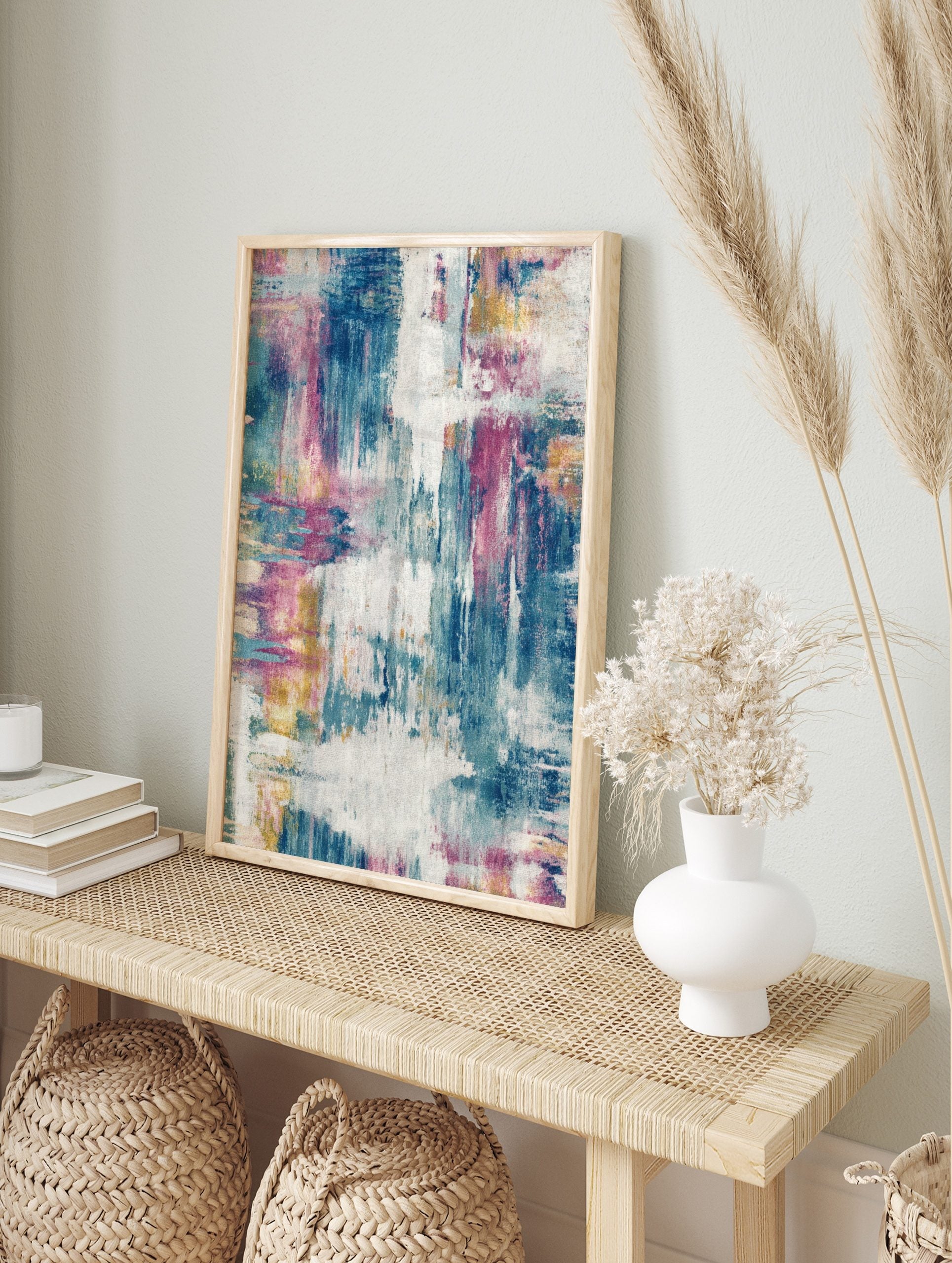 Abstract art print with blue, fuchsia, yellow, and white distressed brushstrokes and textured, in an alternate framed mockup