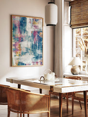 Abstract art print with blue, fuchsia, yellow, and white distressed brushstrokes and textured, in a styled room mockup