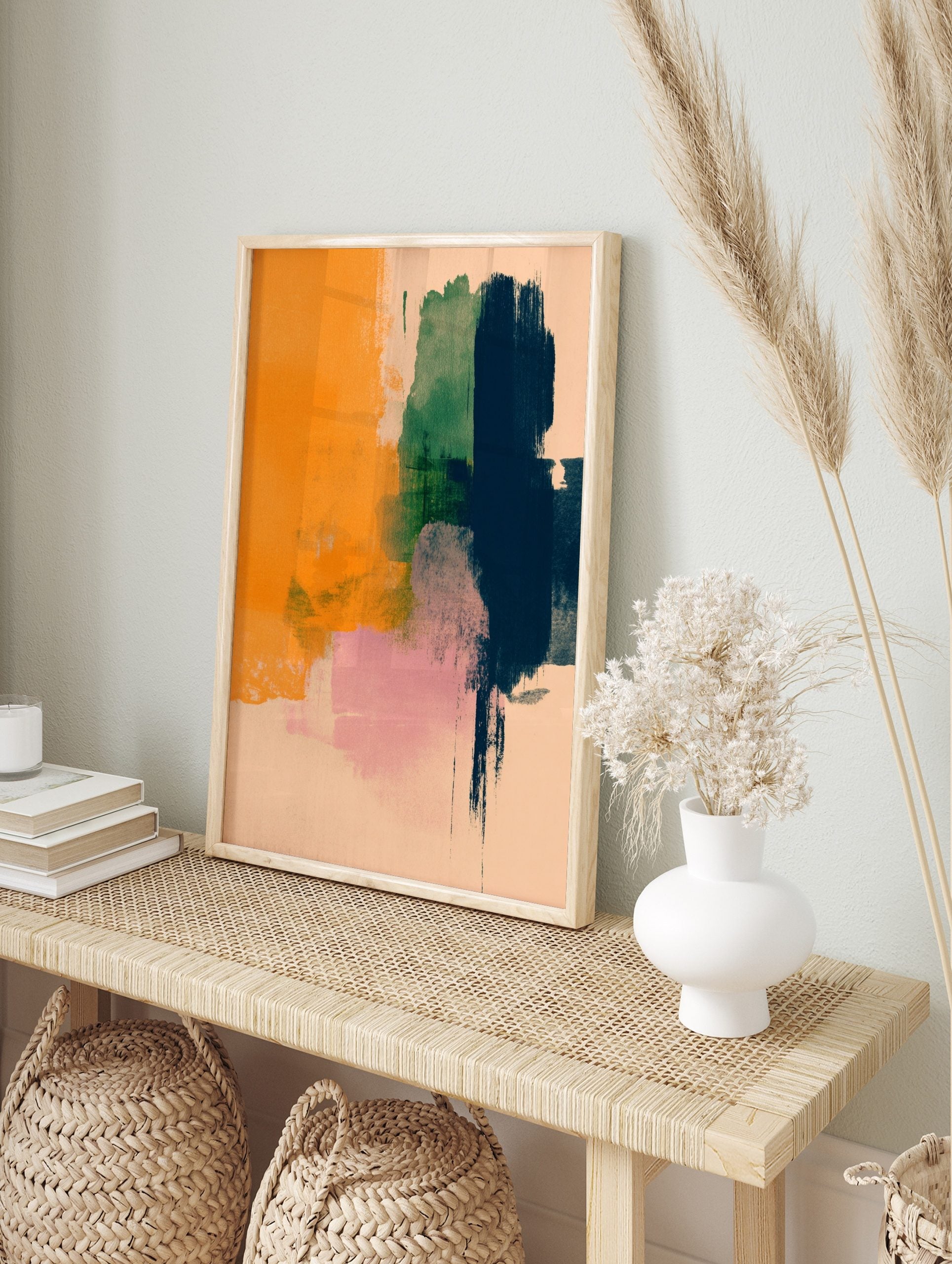 Abstract art print with vertical brushstrokes in orange, green, navy, and pink on a pale, in an alternate framed mockup