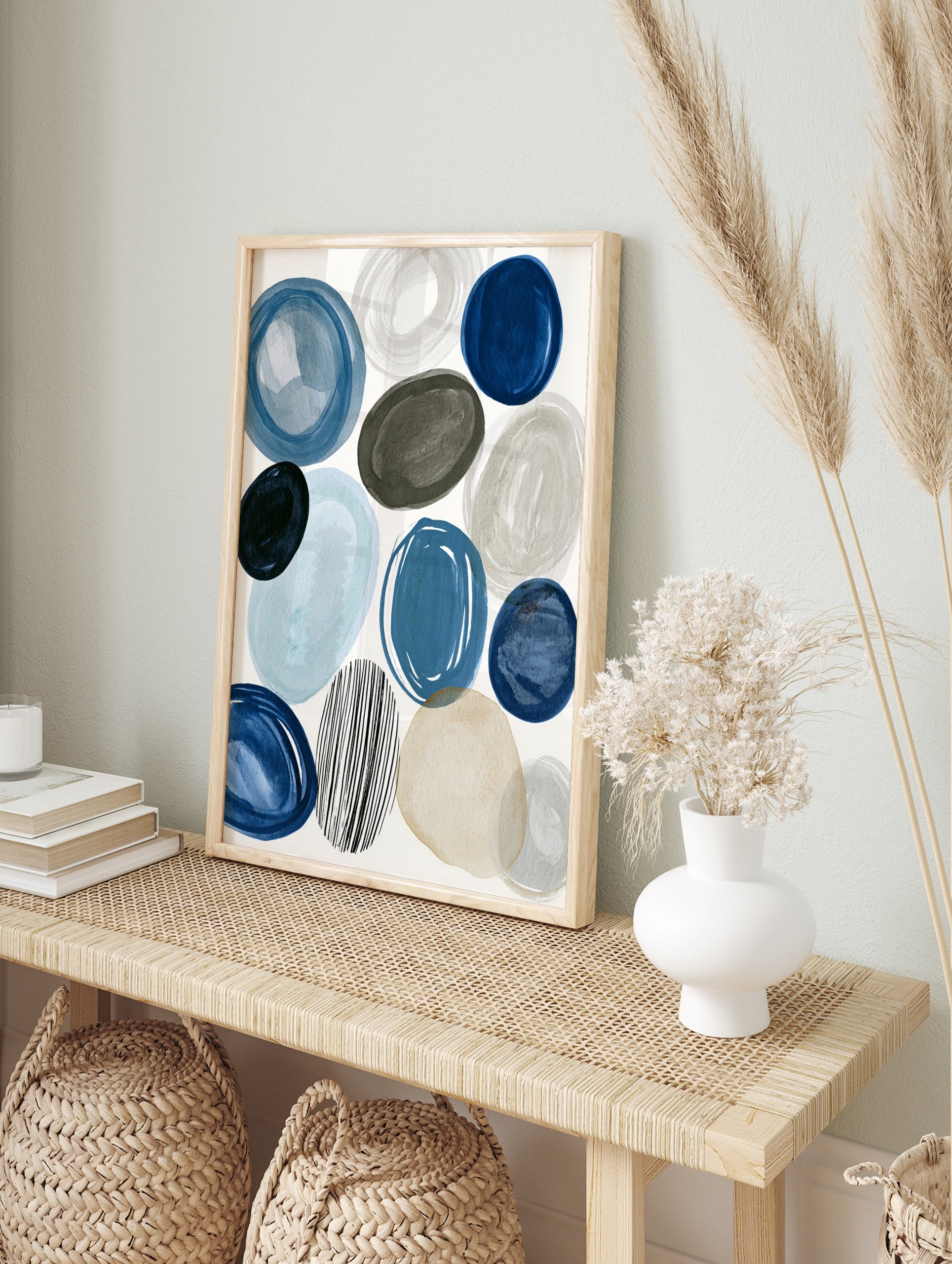 Abstract circles and ovals in blue, grey, and beige with one striped circle on a white, in an alternate framed mockup