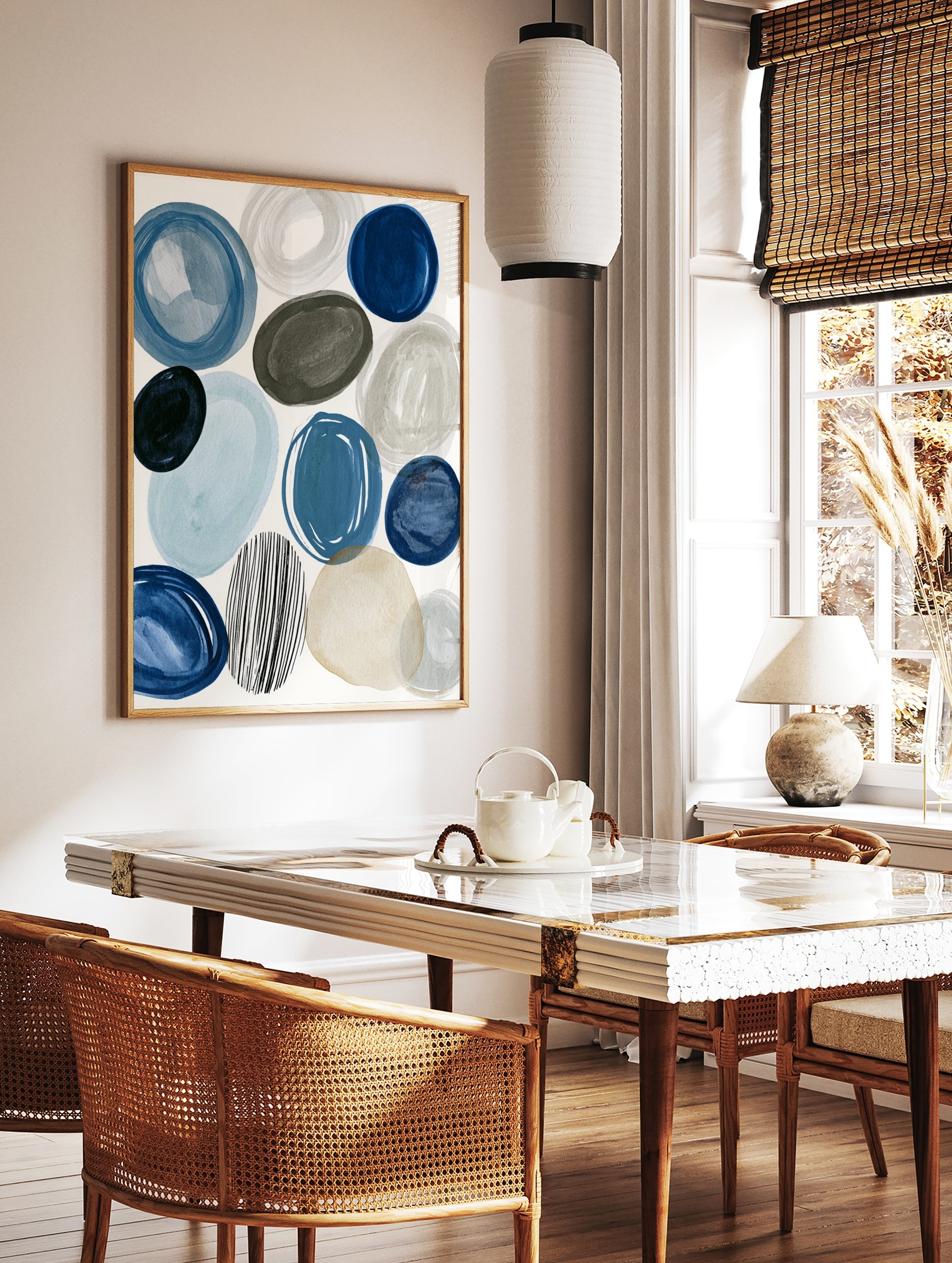 Abstract circles and ovals in blue, grey, and beige with one striped circle on a white background, in a styled room mockup