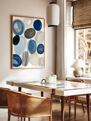Abstract circles and ovals in blue, grey, and beige with one striped circle on a white background, in a styled room mockup