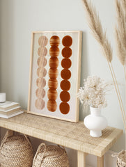 Abstract wall art print with three vertical columns of brown circles featuring vertical, in an alternate framed mockup