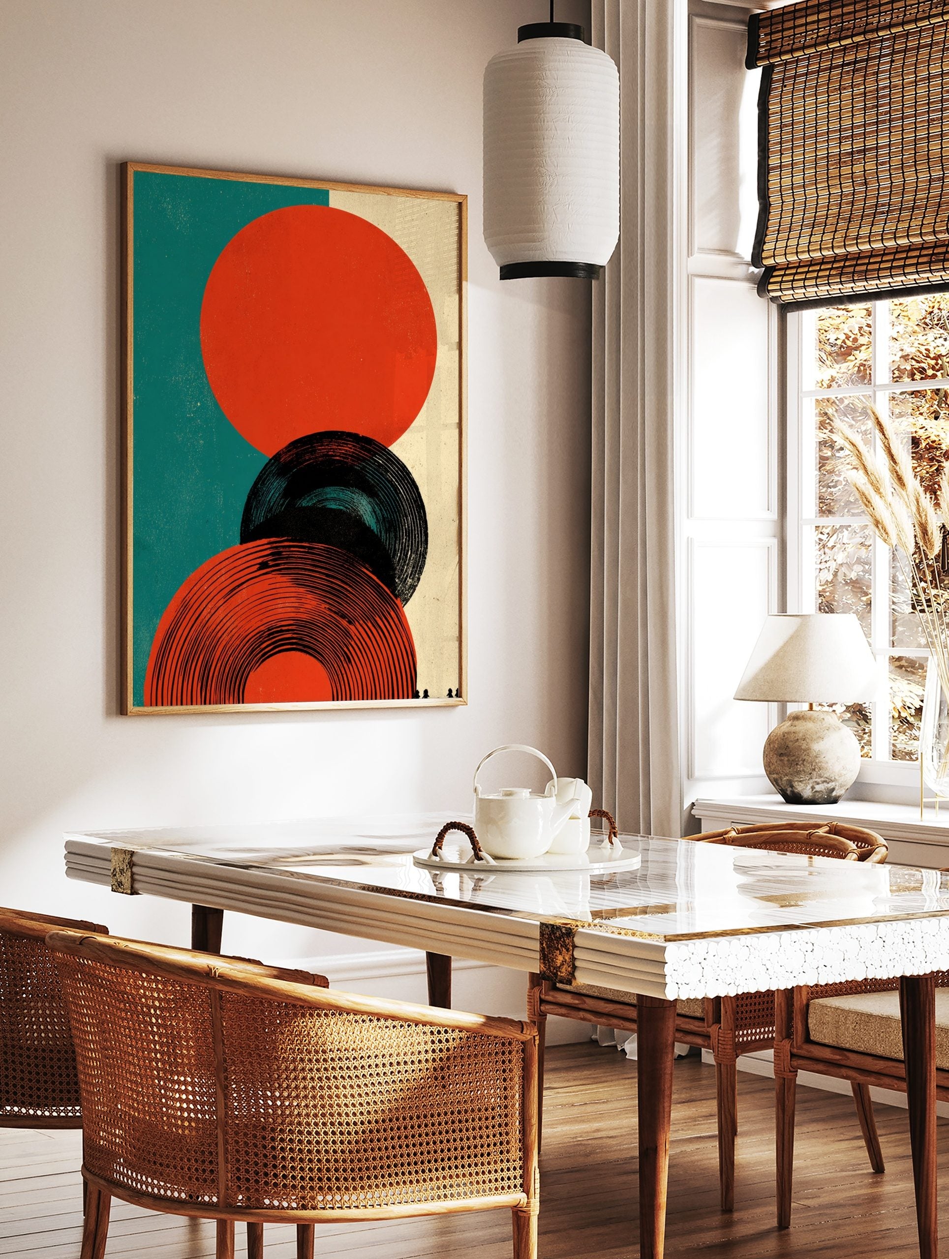 Abstract circles graphic print featuring orange-red and black concentric shapes on teal and beige, in a styled room mockup
