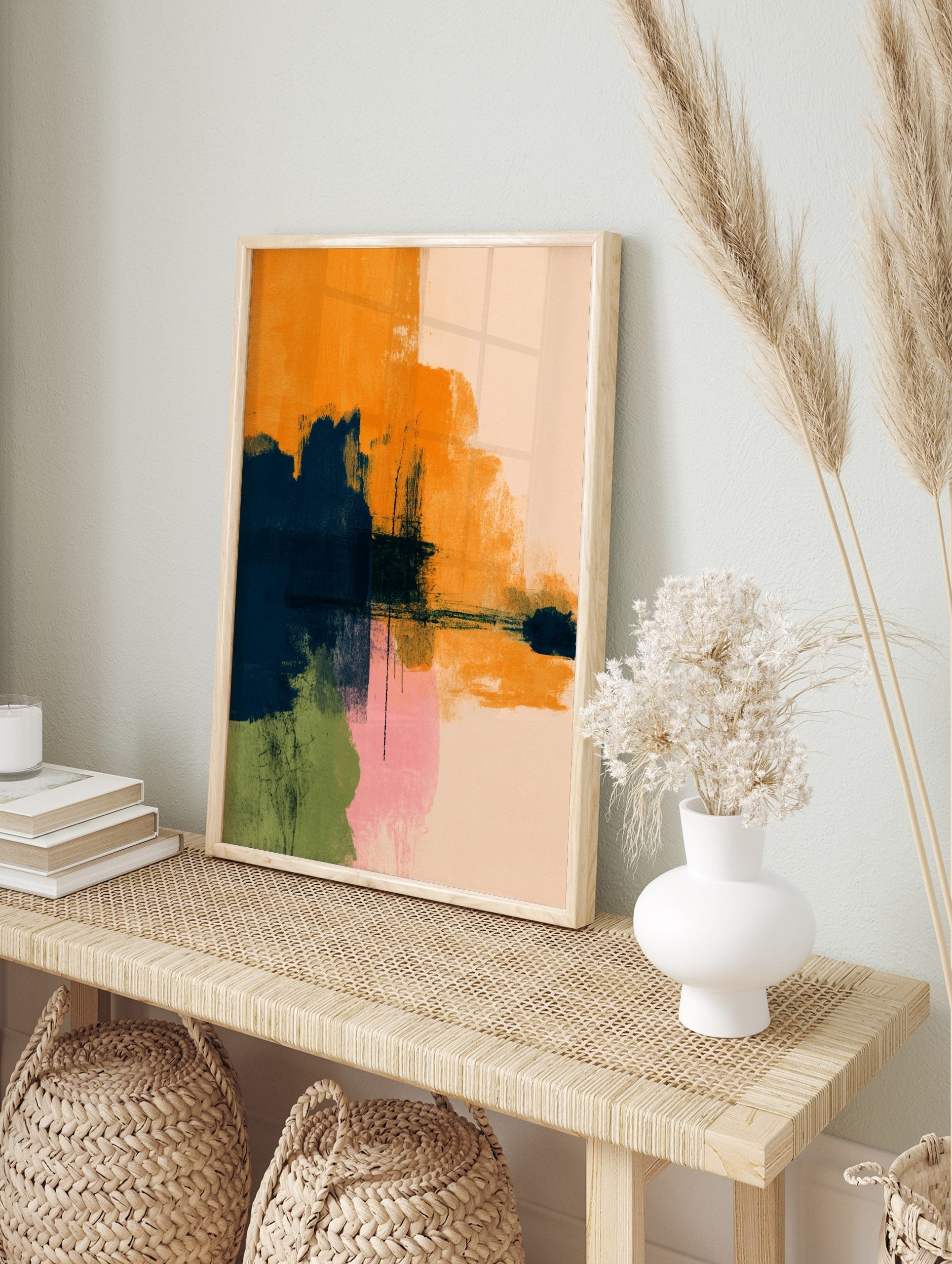 Abstract art print with bold orange, navy blue, pink, and green brushstrokes on a light, in an alternate framed mockup