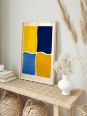 Abstract wall art with four irregular colour blocks in bright yellow, navy blue, medium blue, in an alternate framed mockup