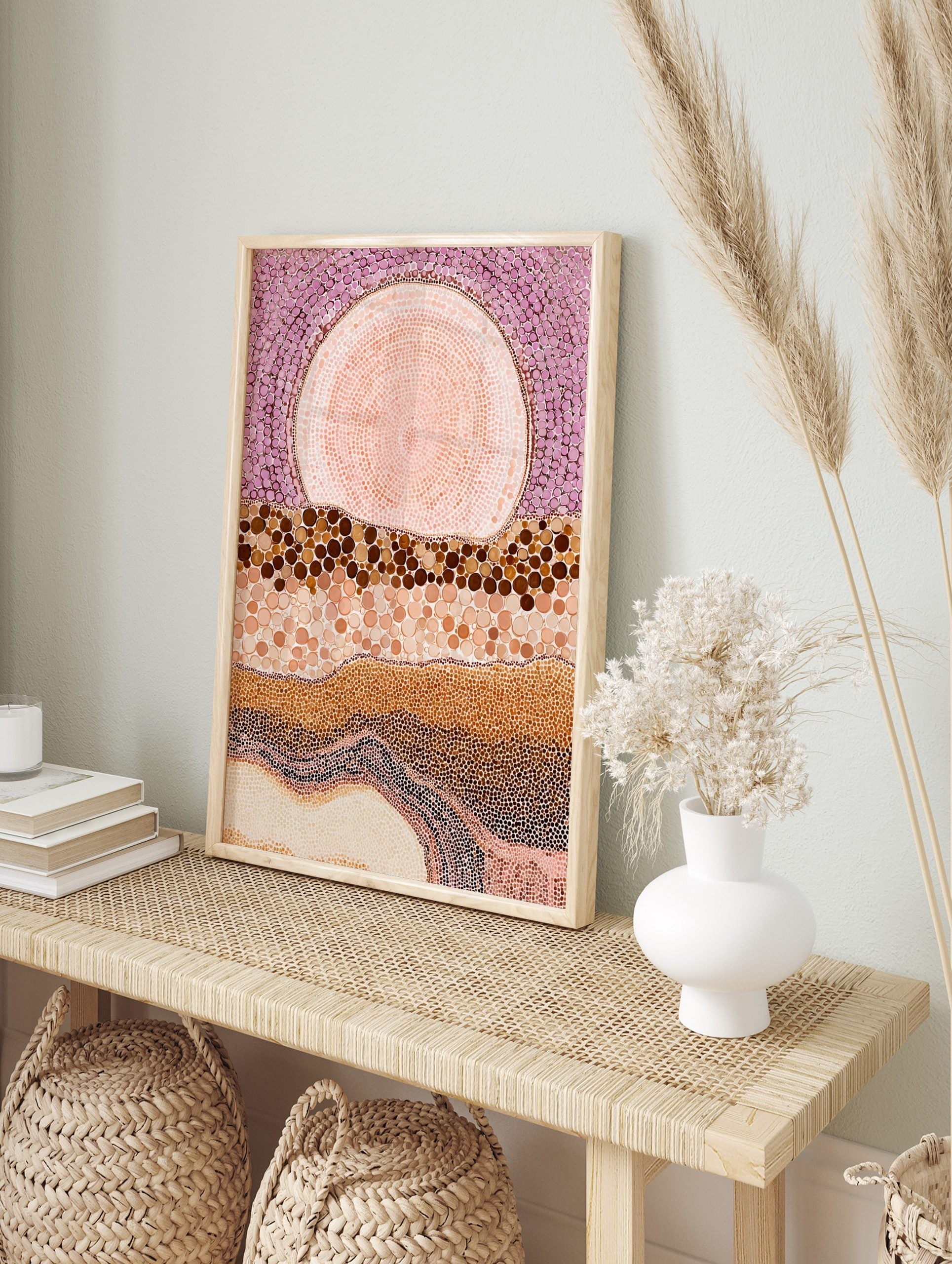 Abstract dot painting wall art with large pink orb, purple dotted sky, and layered brown and, in an alternate framed mockup