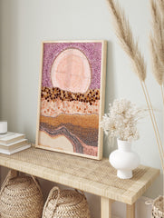 Abstract dot painting wall art with large pink orb, purple dotted sky, and layered brown and, in an alternate framed mockup