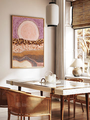 Abstract dot painting wall art with large pink orb, purple dotted sky, and layered brown and beige, in a styled room mockup