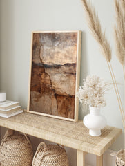 Abstract wall art print with deep cracks and layered textures in brown, beige, and dark earth, in an alternate framed mockup