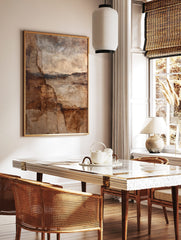 Abstract wall art print with deep cracks and layered textures in brown, beige, and dark earth tones, in a styled room mockup