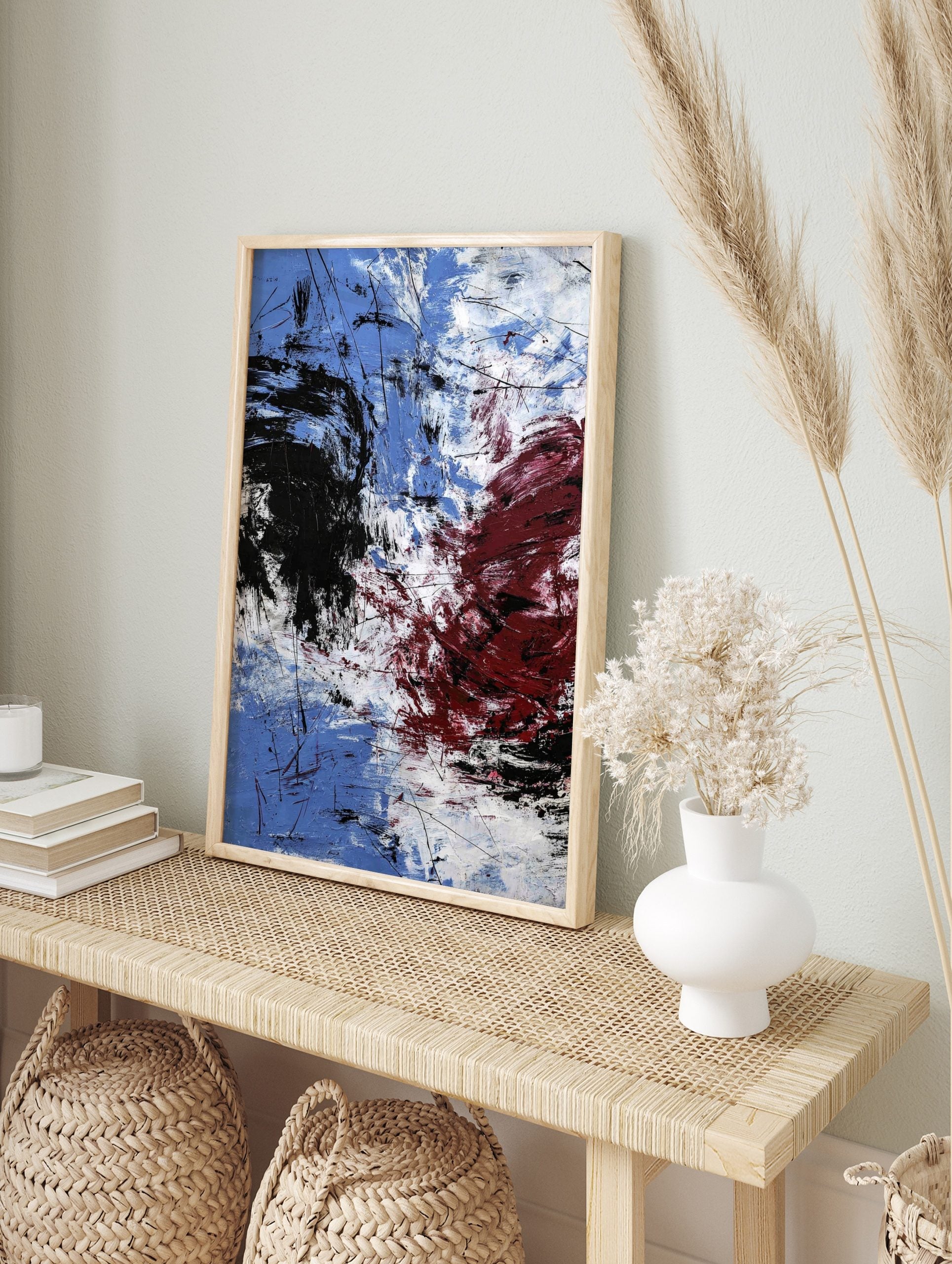 Abstract expressionist art print with blue, white, black, and red energetic brushstrokes and, in an alternate framed mockup