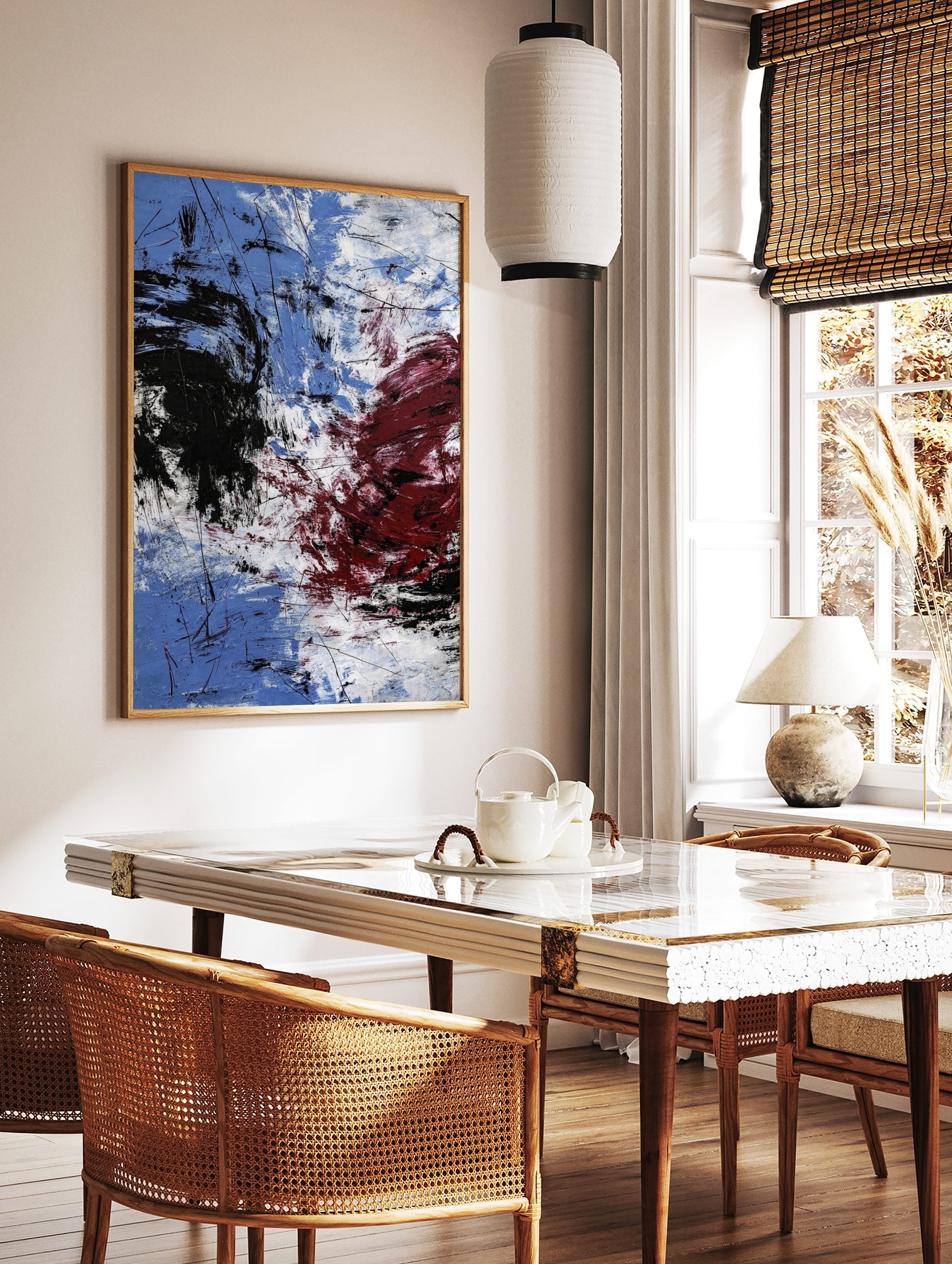 Abstract expressionist art print with blue, white, black, and red energetic brushstrokes and fine, in a styled room mockup