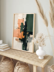 Abstract art print with dark green, peach, and black brushstrokes and lines on a light, in an alternate framed mockup
