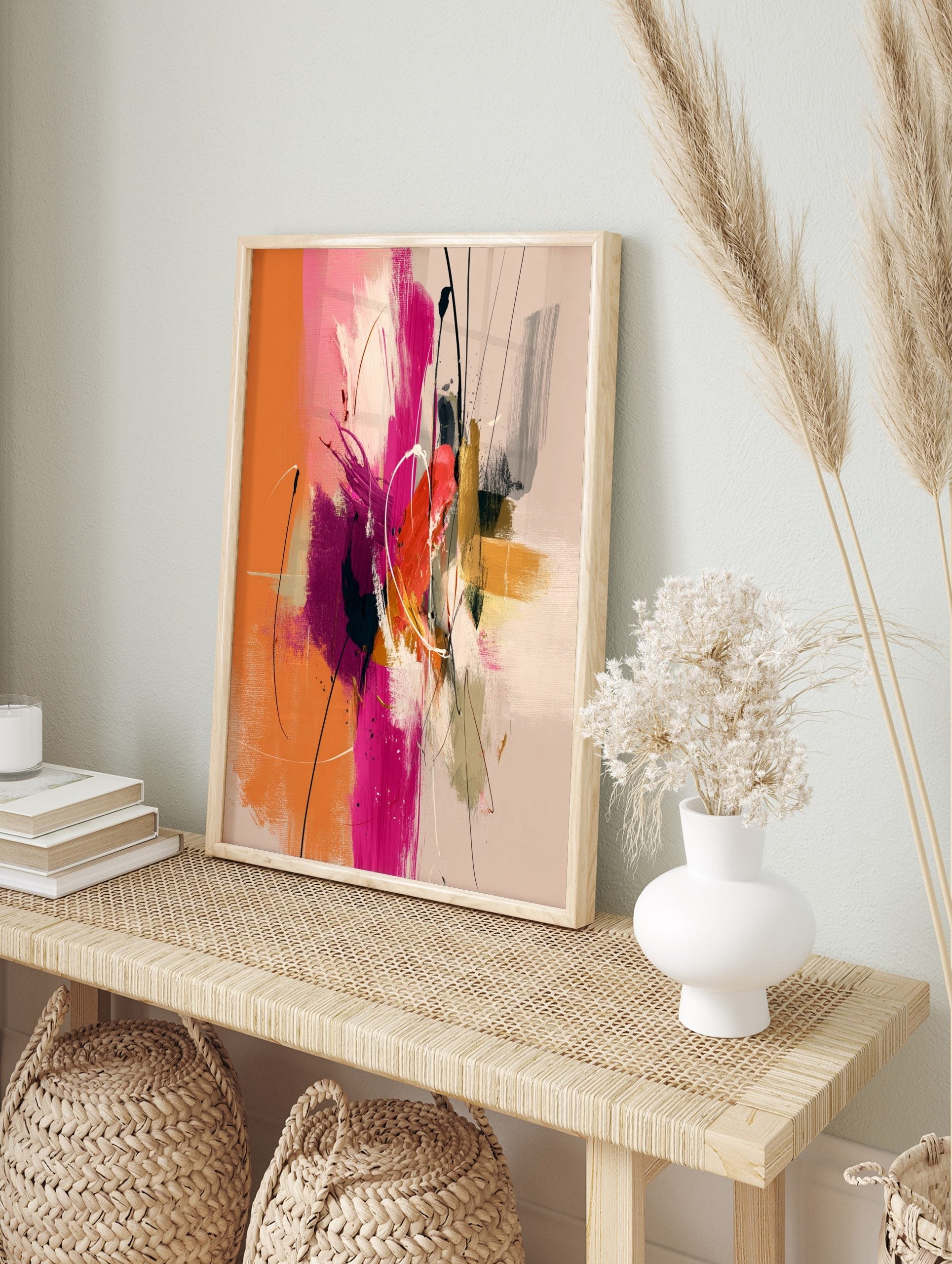 Abstract painting with orange, hot pink, gold, and dark brushstrokes, white lines, and, in an alternate framed mockup