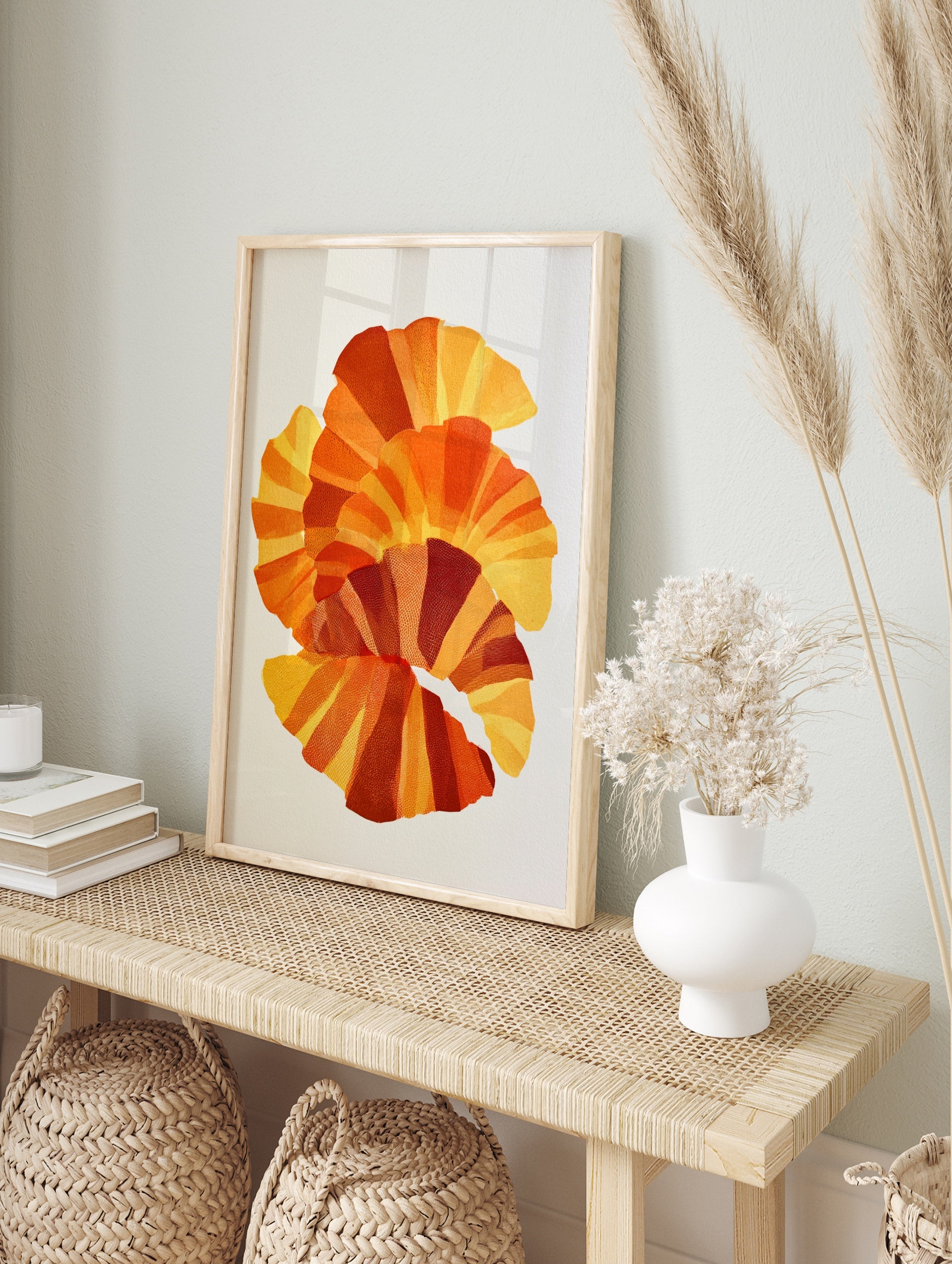 Abstract fan-shaped layered geometric art print in yellow, orange, and red with stippled, in an alternate framed mockup