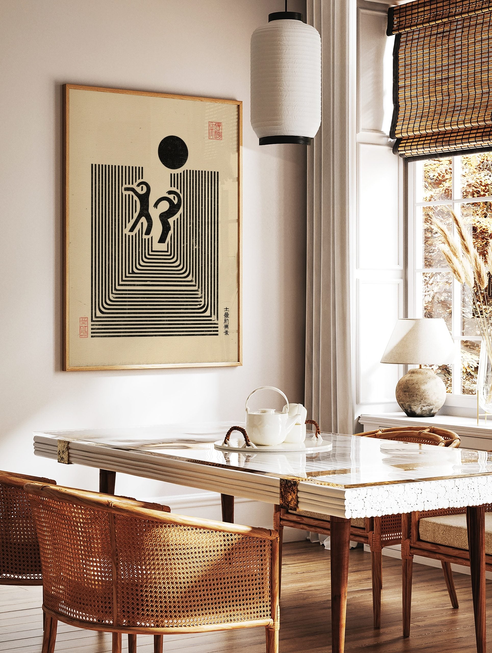 Abstract black figures dancing above concentric lines with a black circle and Japanese text on, in a styled room mockup
