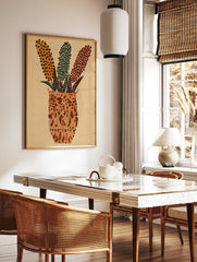 Abstract floral vase wall art with three dotted flower stalks in orange, teal, and purple on a, in a styled room mockup