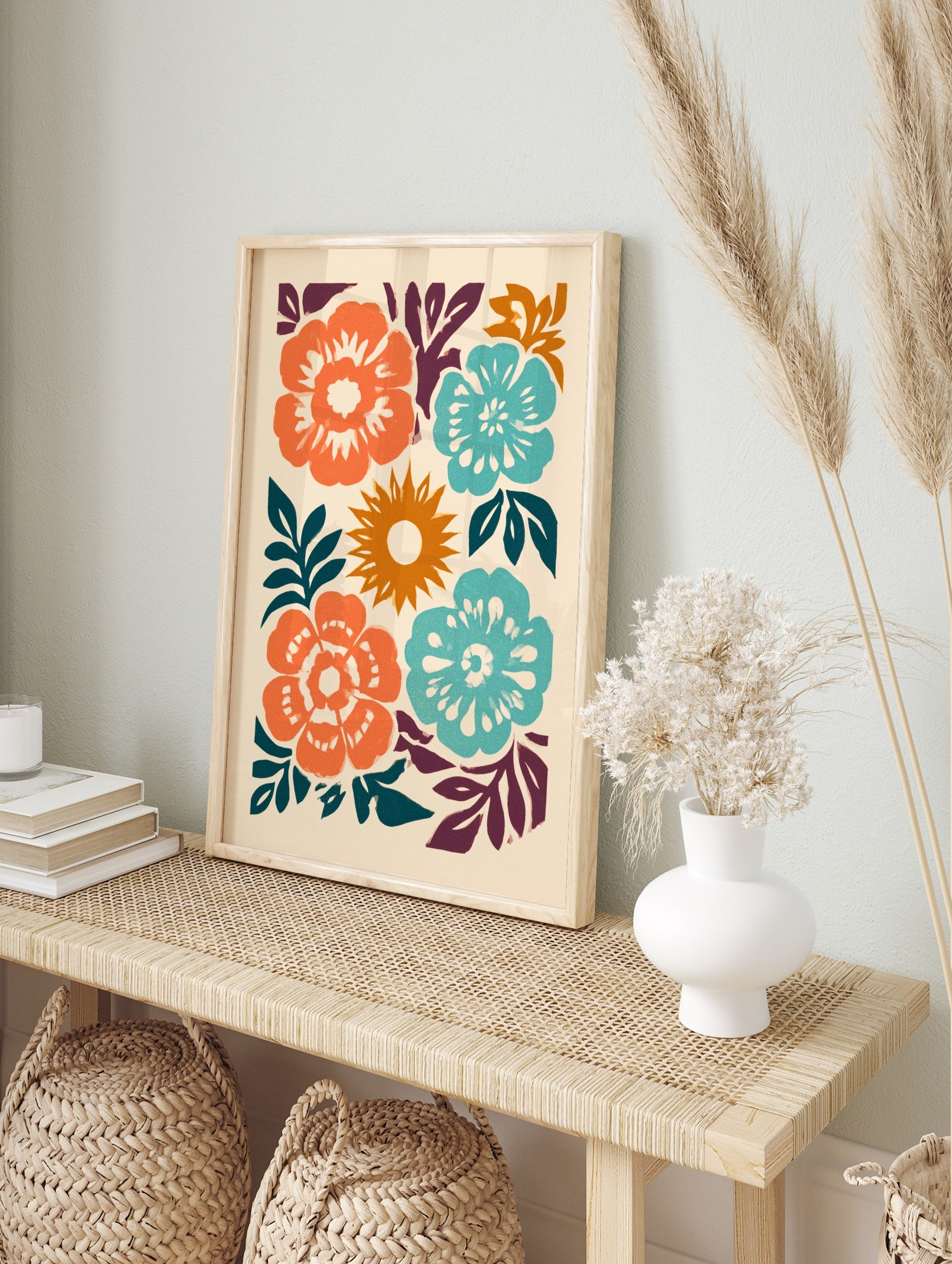 Stylised abstract floral wall art print with orange and teal flowers and a central sun on a, in an alternate framed mockup