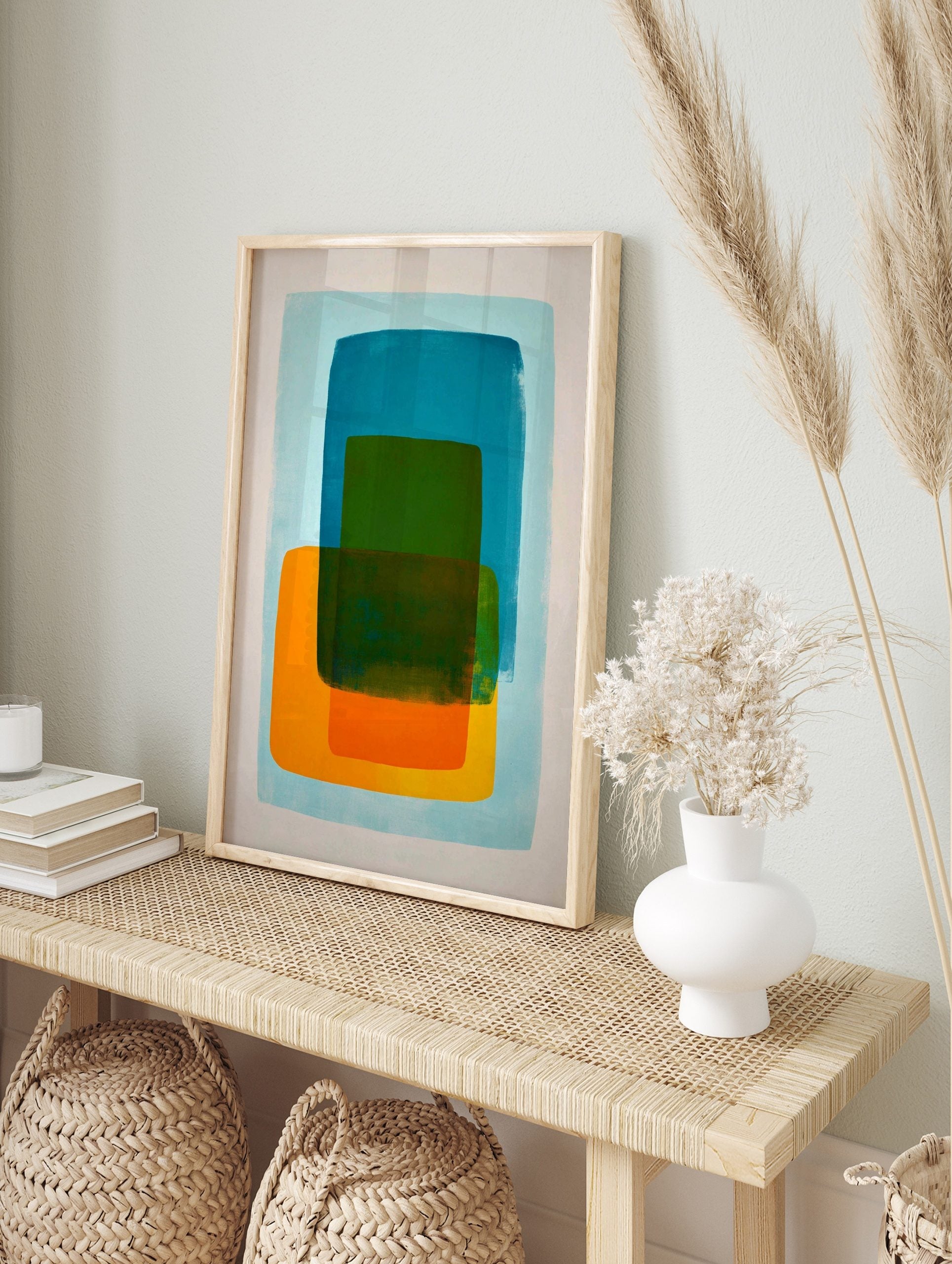 Abstract art print with layered teal, green, and orange rounded rectangles on a light blue, in an alternate framed mockup