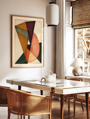 Abstract geometric wall art with overlapping triangles and circular shapes in purple, orange, and, in a styled room mockup
