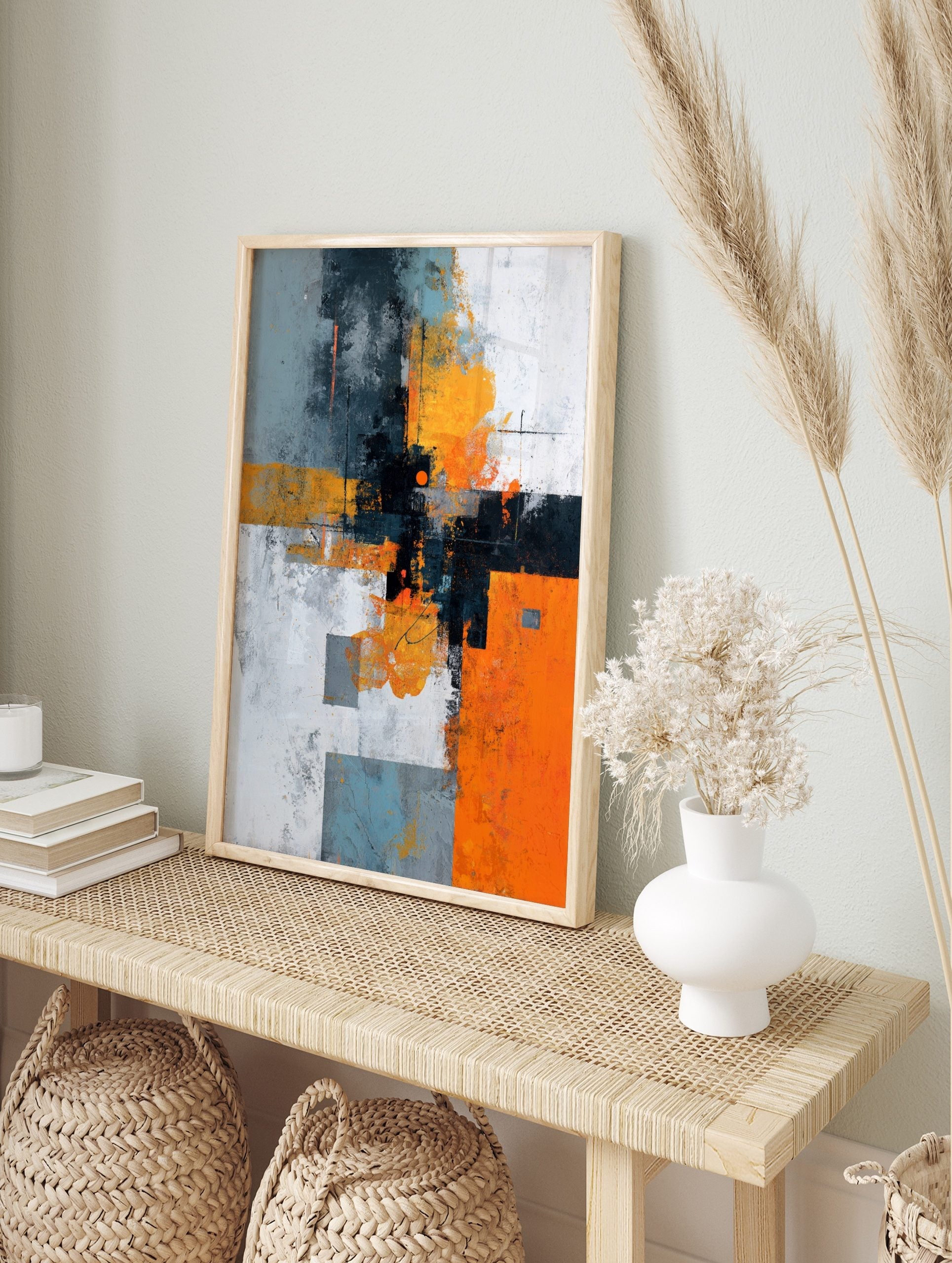 Abstract geometric wall art with orange, grey, black, and white blocks, distressed textures, in an alternate framed mockup