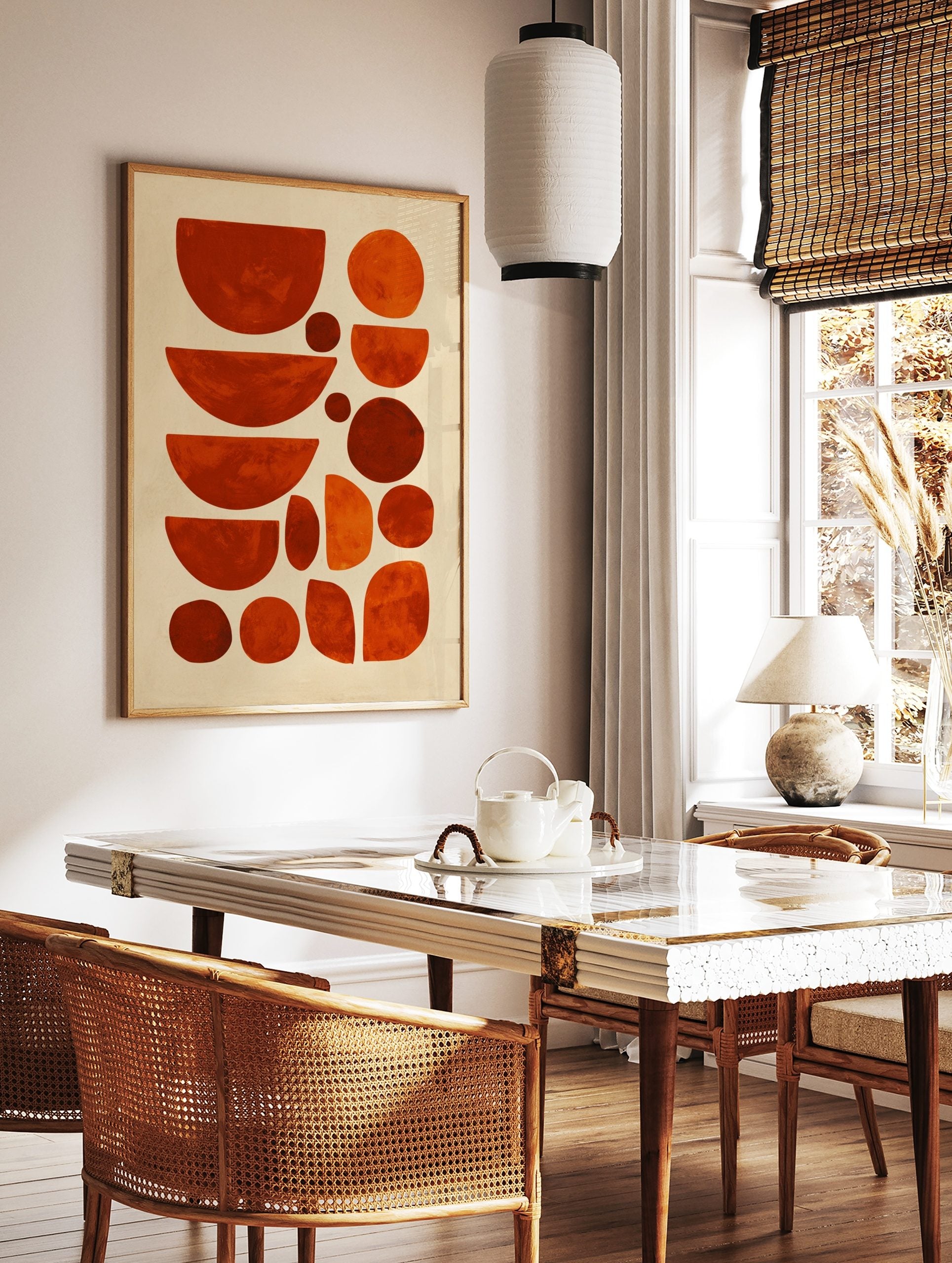 Abstract geometric art print with organic shapes in varying shades of orange and red against a, in a styled room mockup