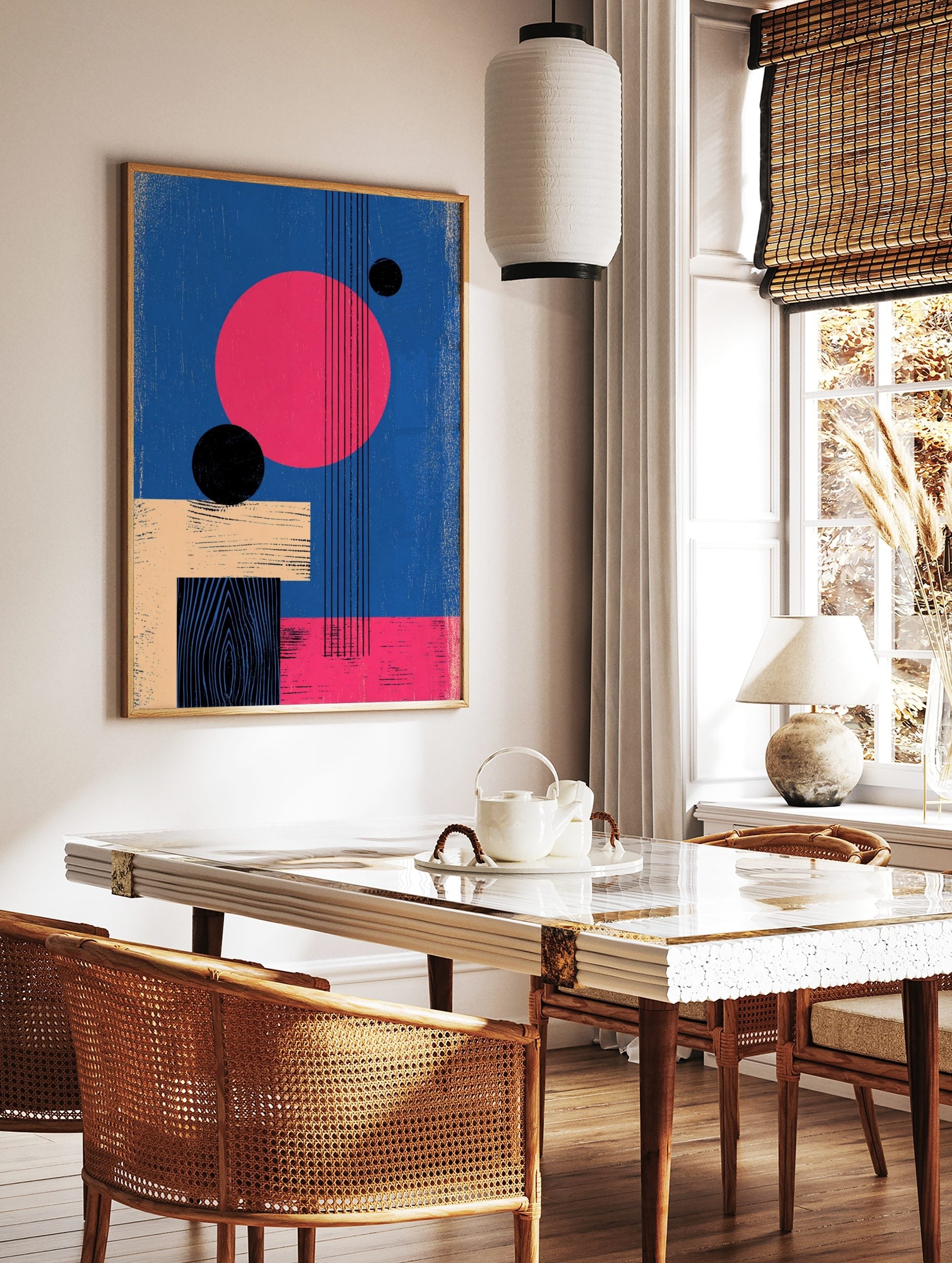 Abstract geometric wall art with large pink circle, black spheres, beige and black rectangles on a, in a styled room mockup