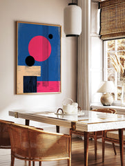 Abstract geometric wall art with large pink circle, black spheres, beige and black rectangles on a, in a styled room mockup