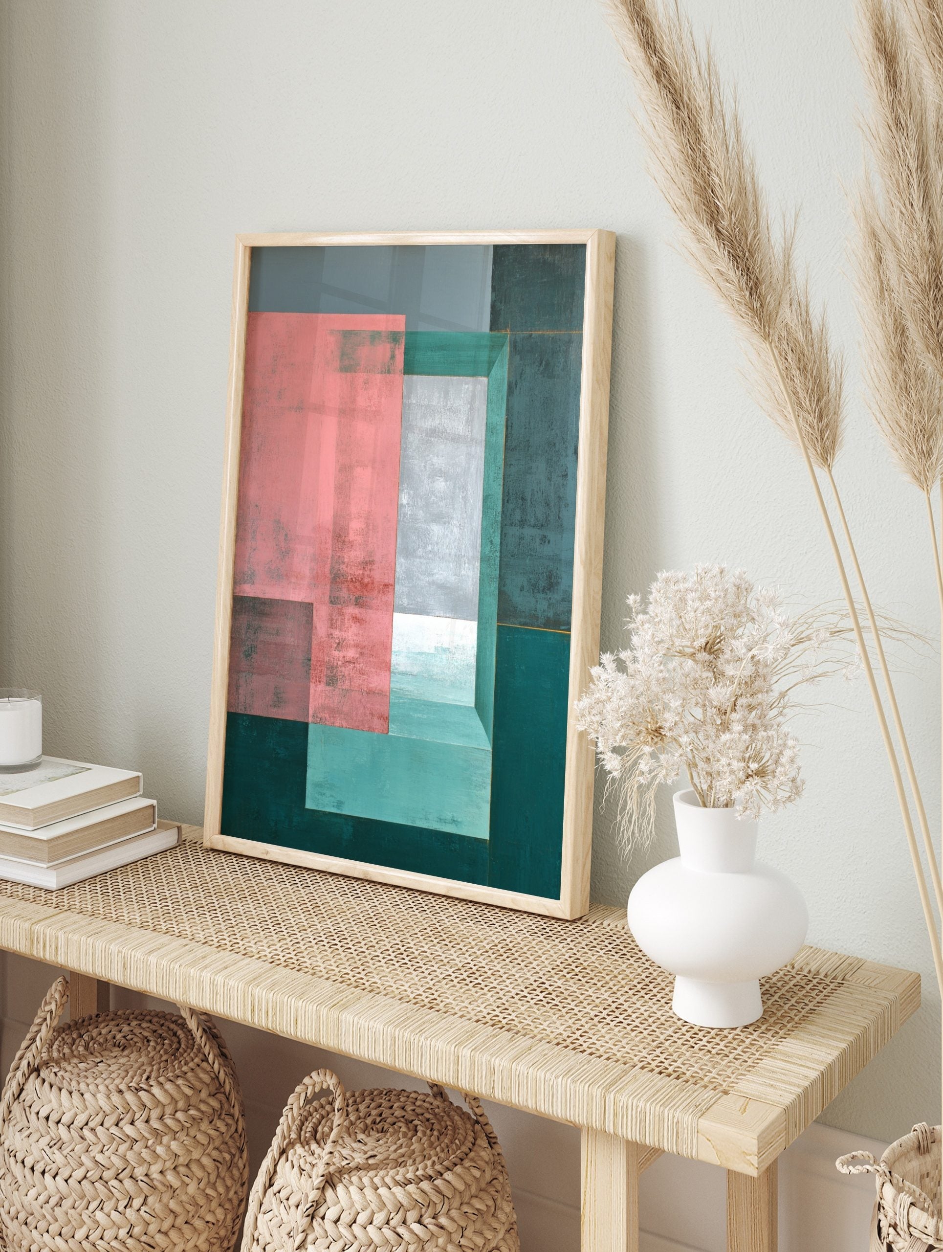 Abstract geometric wall art with layered pink, grey, and teal rectangles, creating a sense of, in an alternate framed mockup