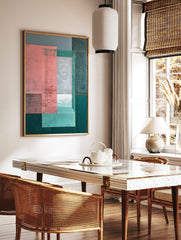 Abstract geometric wall art with layered pink, grey, and teal rectangles, creating a sense of depth, in a styled room mockup