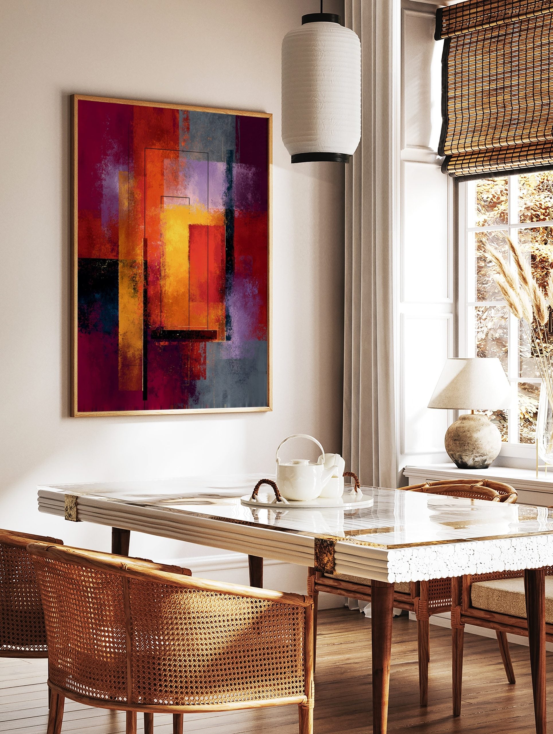 Abstract geometric art print with layered rectangles in red, orange, yellow, and purple with black, in a styled room mockup