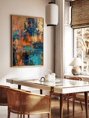 Abstract textured wall art with metallic gold, deep teal, and burnt orange colours, resembling, in a styled room mockup