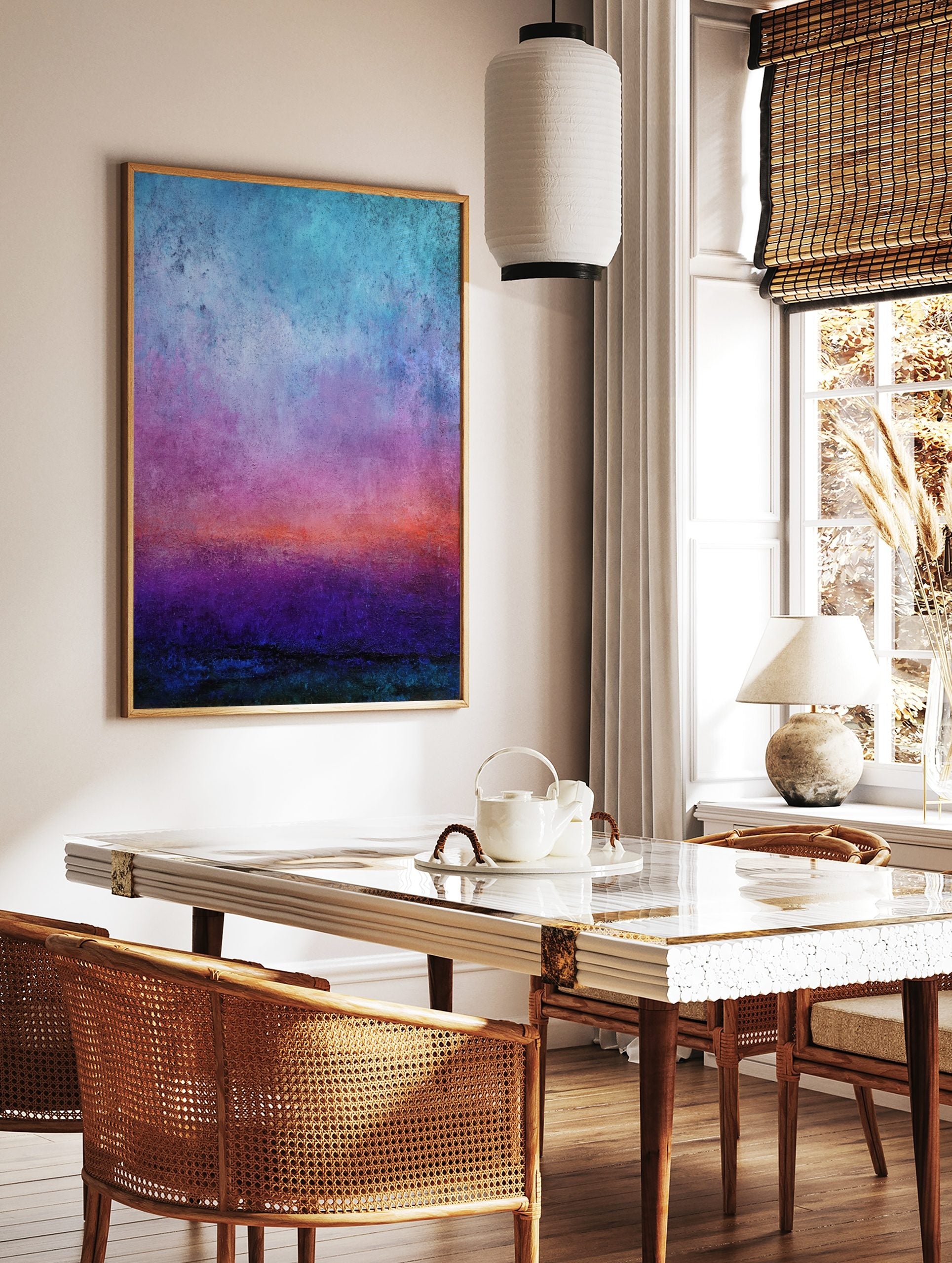 Abstract gradient art print with textured bands of blue, purple, orange, and deep teal colours, in a styled room mockup