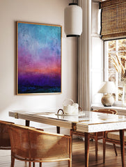 Abstract gradient art print with textured bands of blue, purple, orange, and deep teal colours, in a styled room mockup