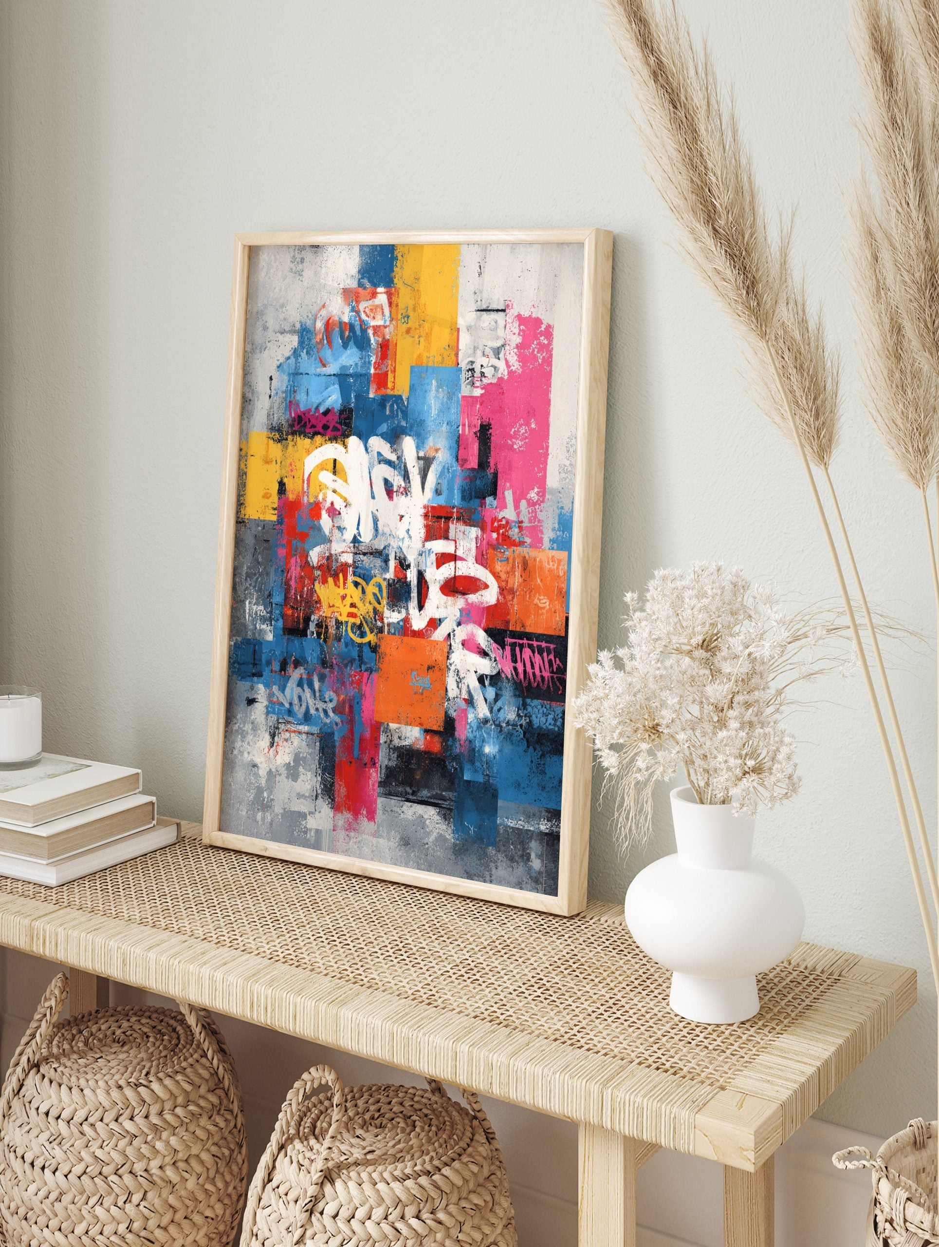 Abstract graffiti wall art print with white, yellow, pink tags on layered blue, red, grey, in an alternate framed mockup