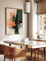 Abstract art print with vertical green and black blocks, horizontal peach and beige strokes, and, in a styled room mockup