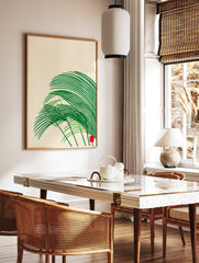 Abstract green grass-like shapes with sweeping curves and a small red square on a cream background, in a styled room mockup
