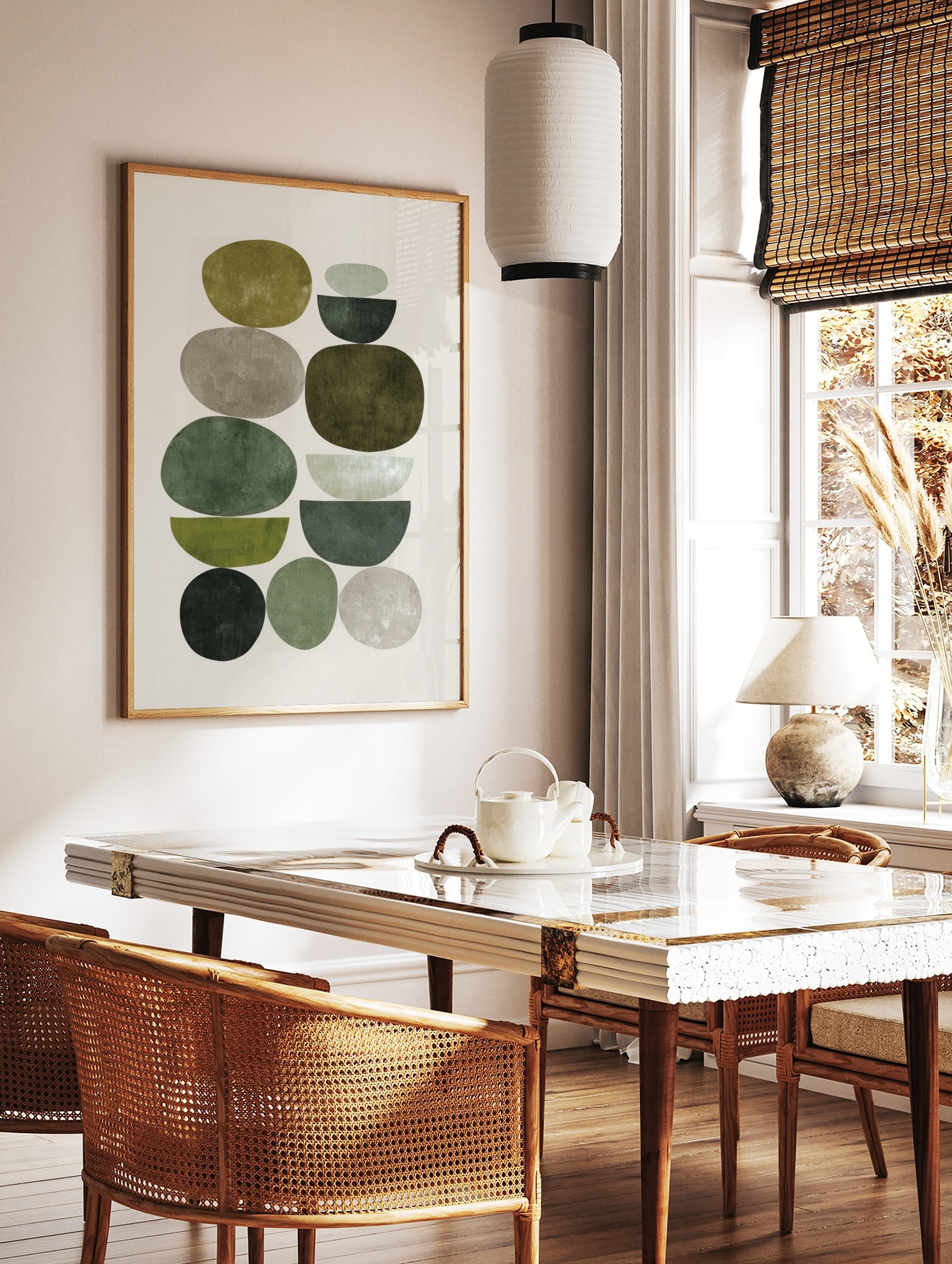 Abstract art print with stacked organic and semi-circular shapes in green and grey earth tones, in a styled room mockup