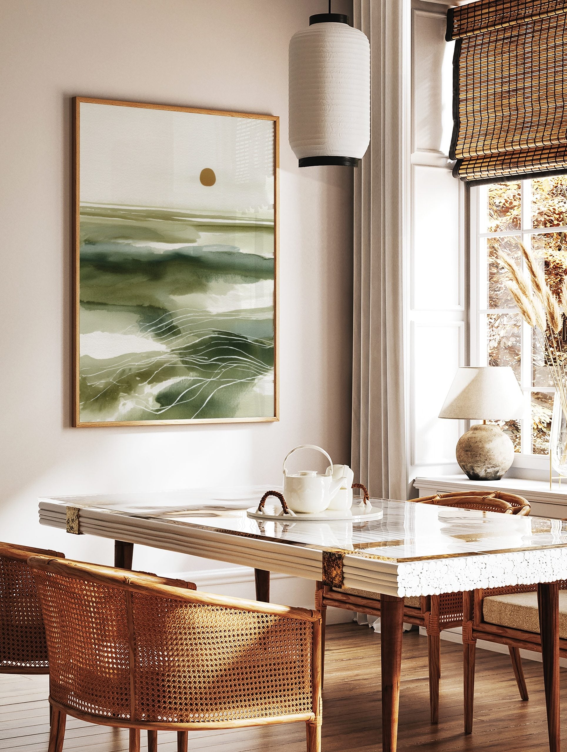 Abstract green seascape wall art with layered washes, white wavy lines, and a golden sun on, in a styled room mockup