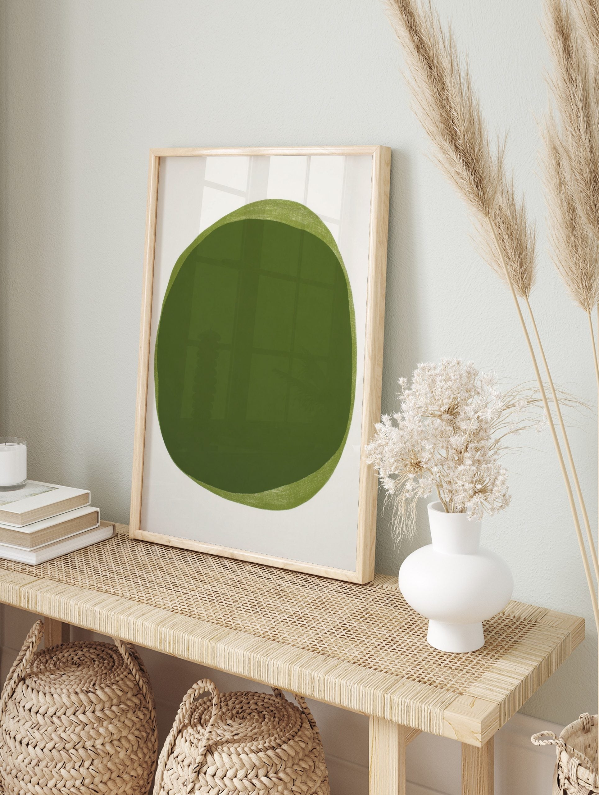 Abstract green organic shape art print with layered light and dark green on a white background, in an alternate framed mockup