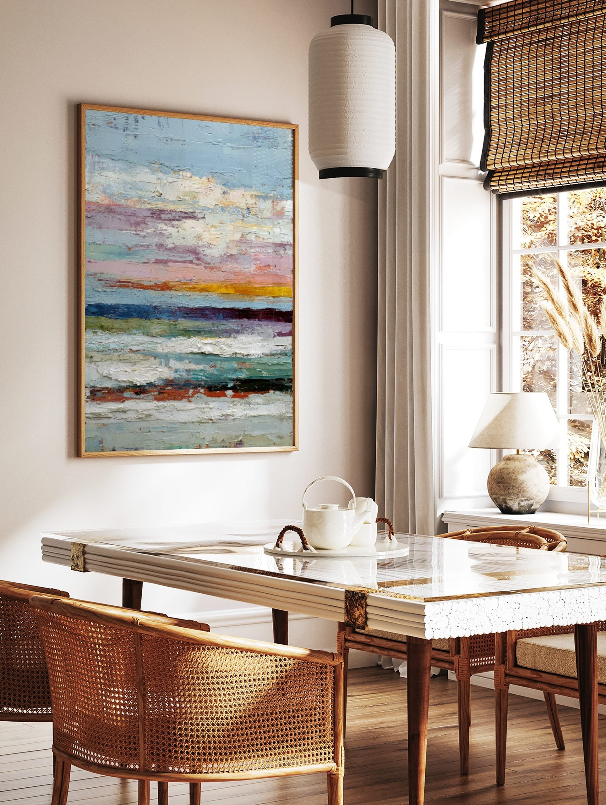 Textured abstract painting with horizontal stripes in blue, pink, yellow, white, and dark tones, in a styled room mockup
