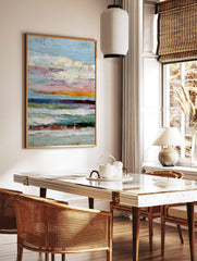 Textured abstract painting with horizontal stripes in blue, pink, yellow, white, and dark tones, in a styled room mockup