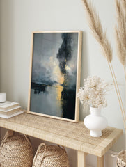 Abstract art print with dark grey, blue, and gold colours depicting a misty landscape with, in an alternate framed mockup