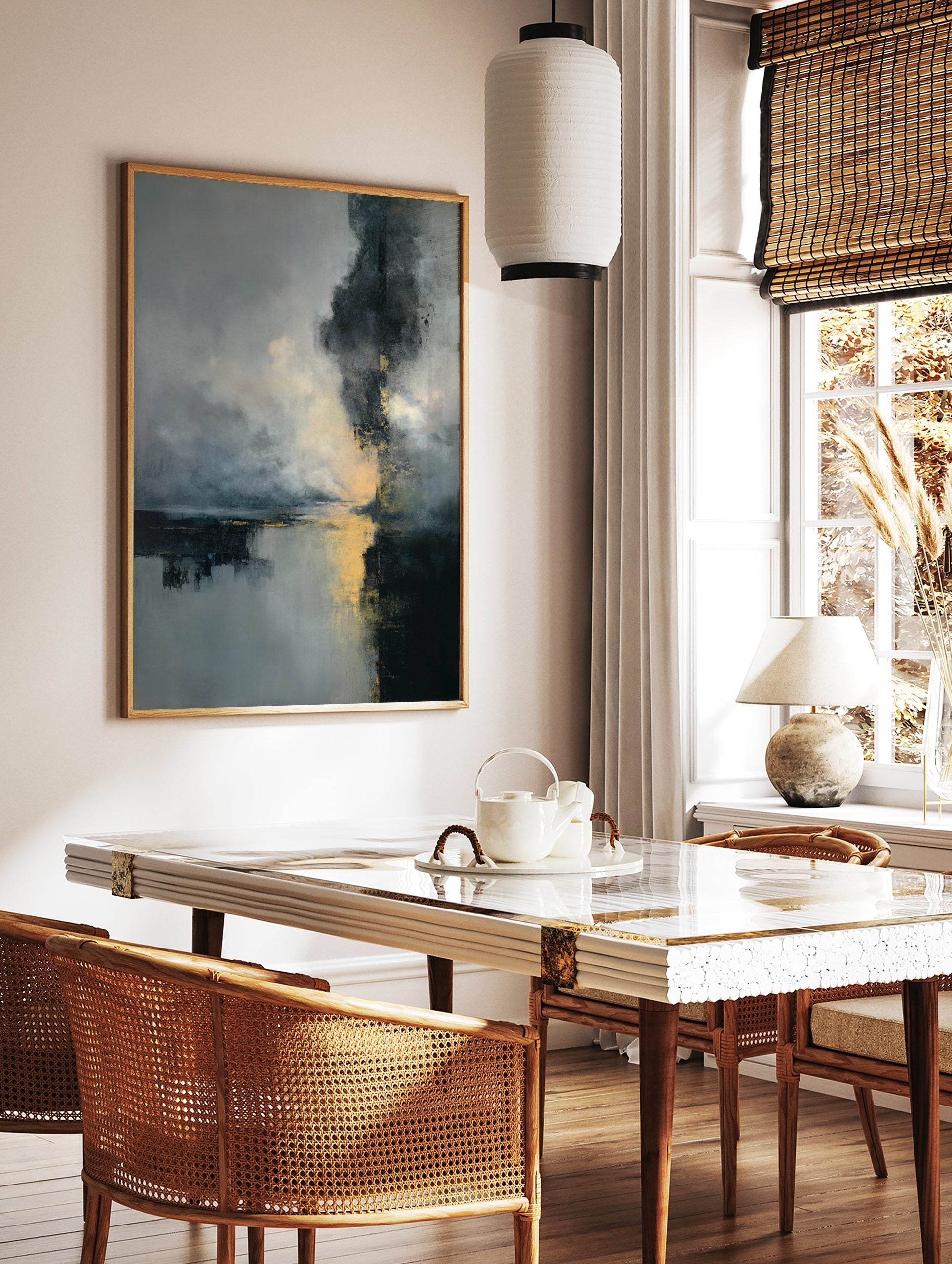Abstract art print with dark grey, blue, and gold colours depicting a misty landscape with, in a styled room mockup
